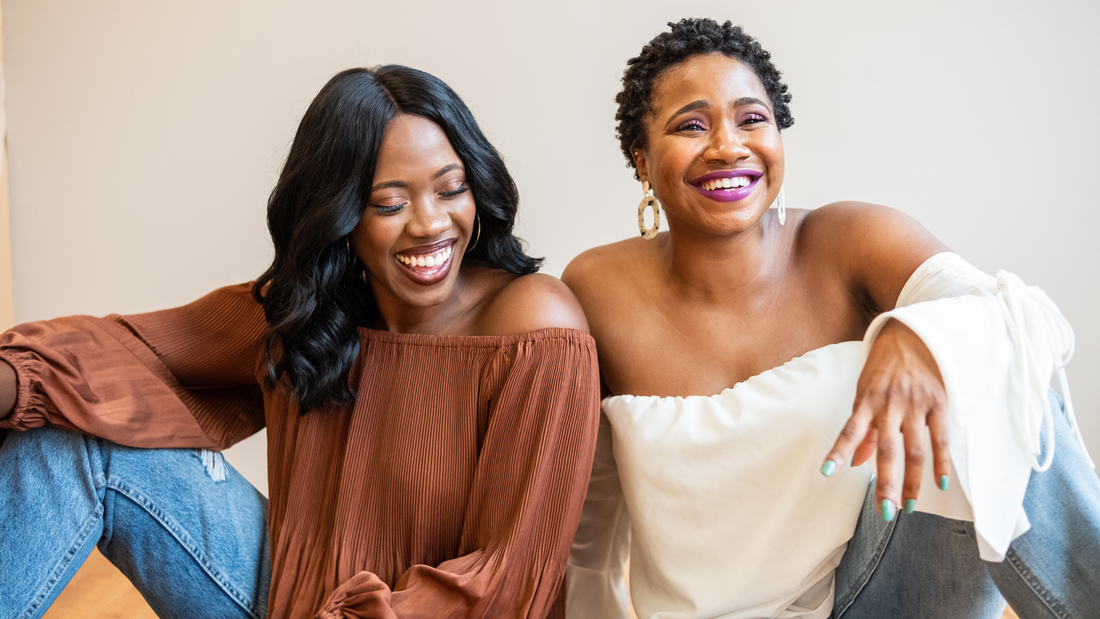 Women laughing and smiling together after discovering their unique personal styles and fashion identities.