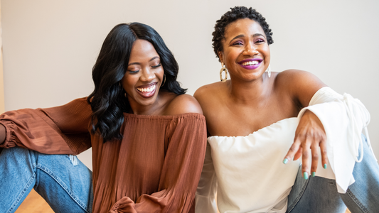 Women laughing and smiling together after discovering their unique personal styles and fashion identities.